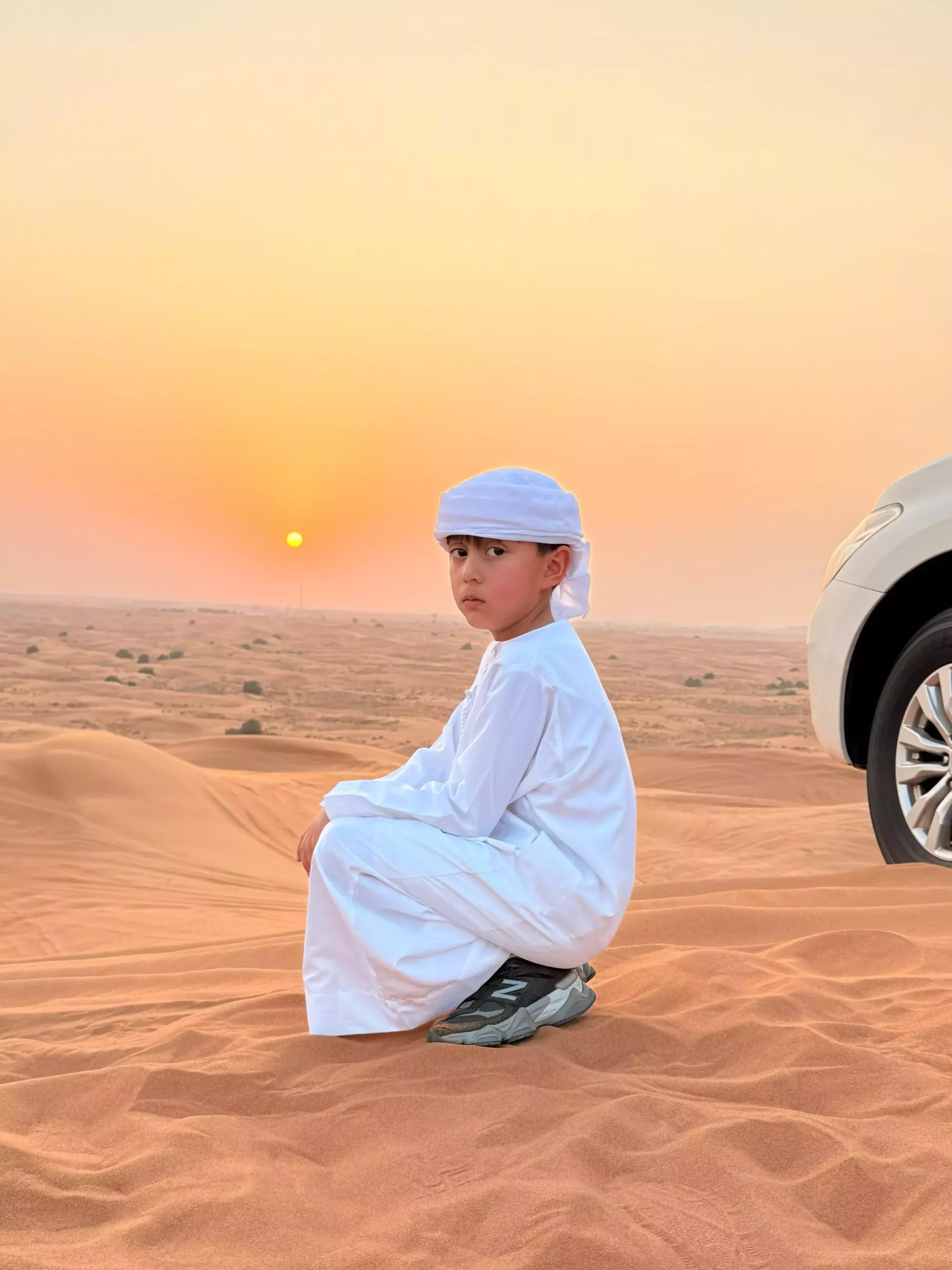 Desert safari Dubai with kids enjoying a family sunset in the Arabian desert